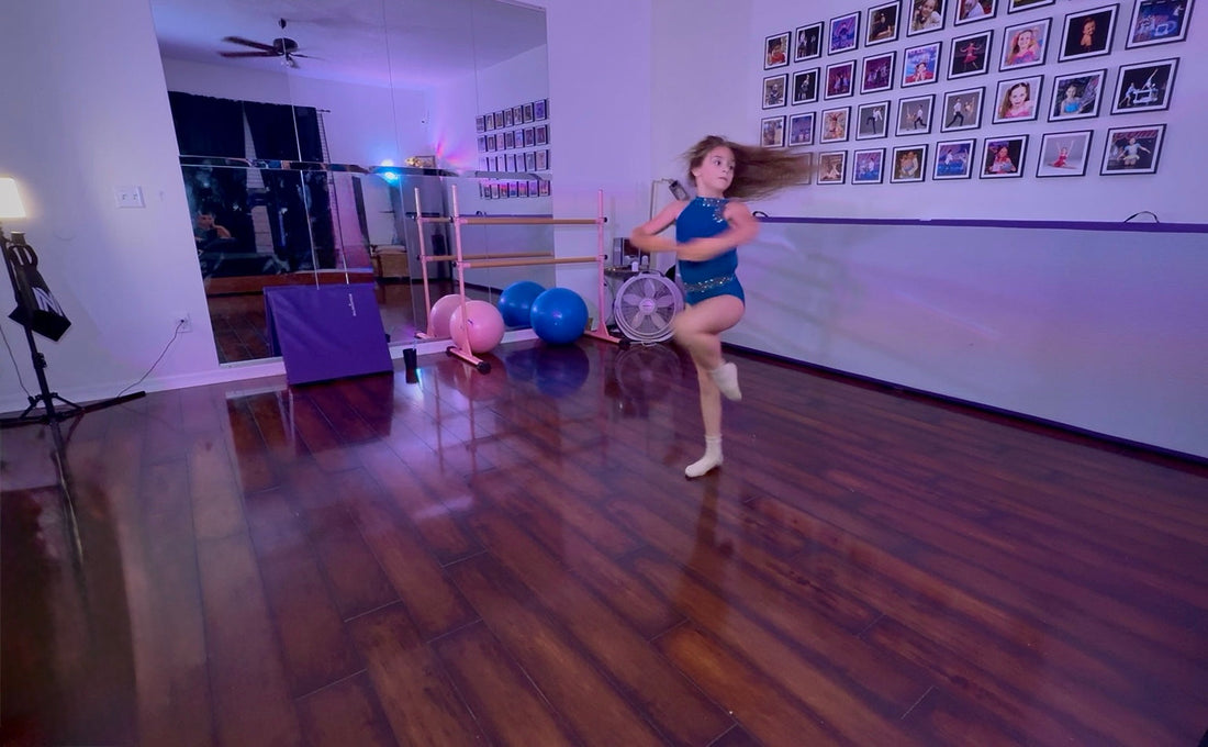 Home dance studio with mirror wall, freestanding ballet barre, conditioning equipment, and young dancer practicing turns.