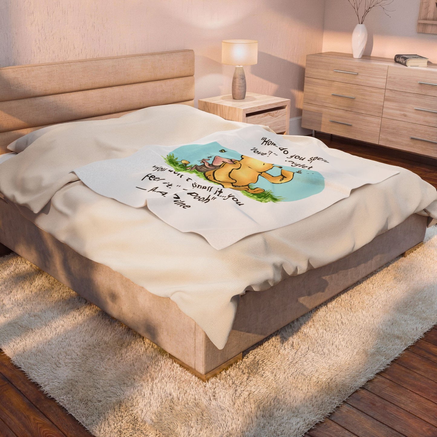 Bedroom with a queen bed covered by a pooh How do you spell love 50 x 60 blanket featuring a graphic design.