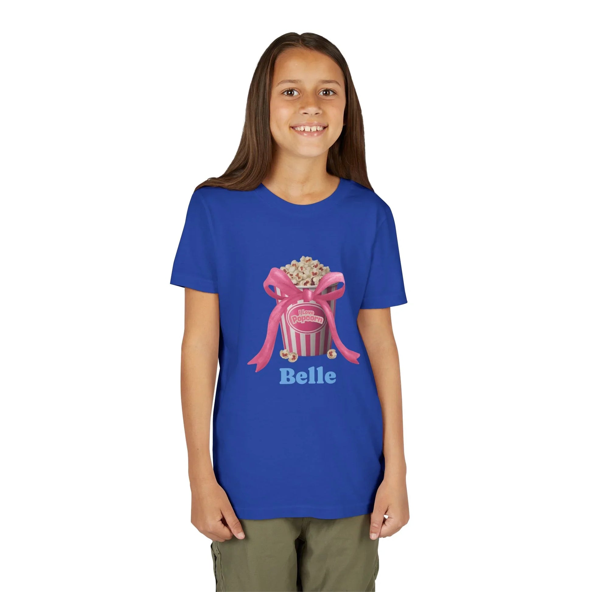 Smiling girl wearing blue t-shirt with popcorn bucket and pink bow graphic and name Belle