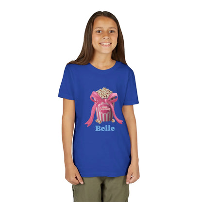 Smiling girl wearing blue t-shirt with popcorn bucket and pink bow graphic and name Belle
