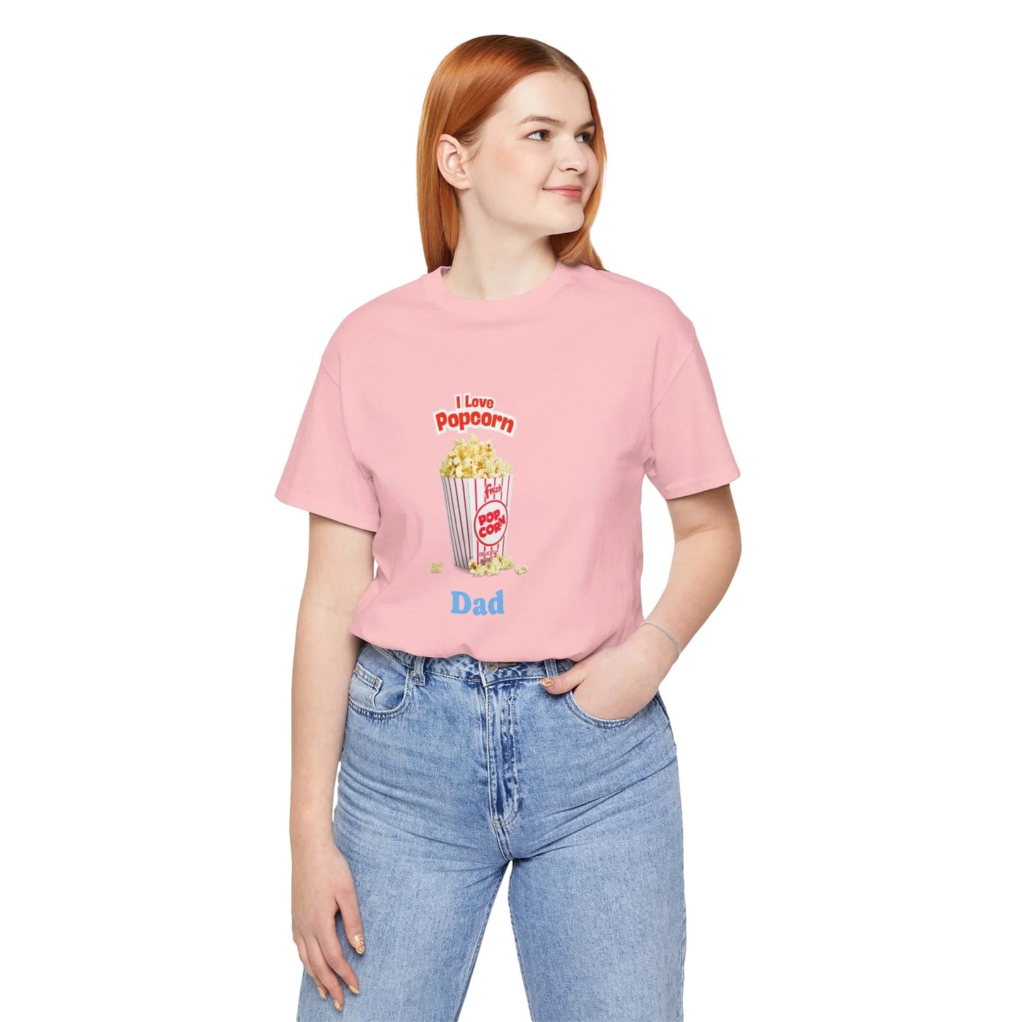 Woman wearing pink t-shirt with popcorn illustration and text 'I Love Popcorn Dad', paired with blue jeans