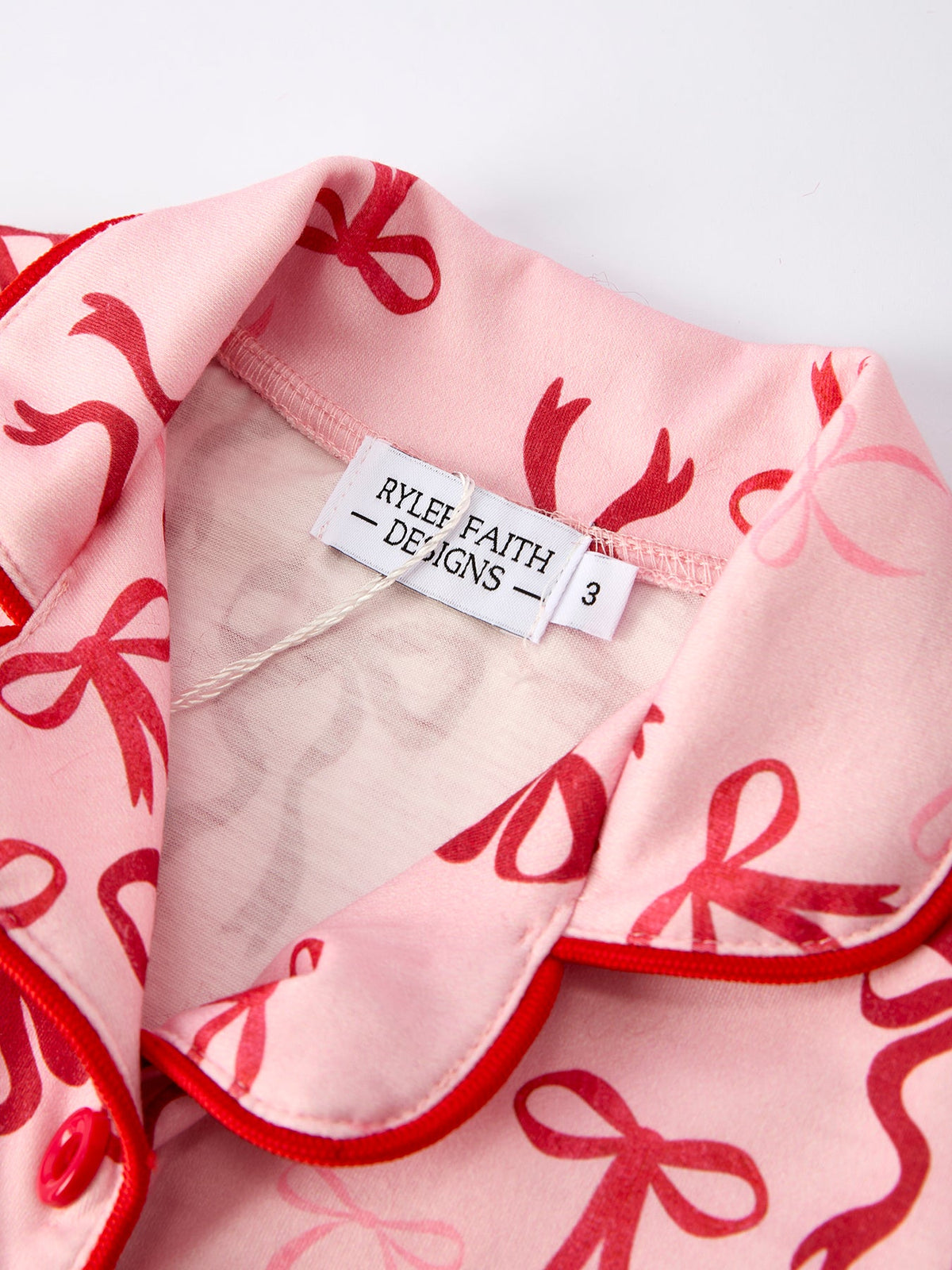 Girls Christmas Pajamas | Pink Bow Furry Trim: Collar and brand label detail