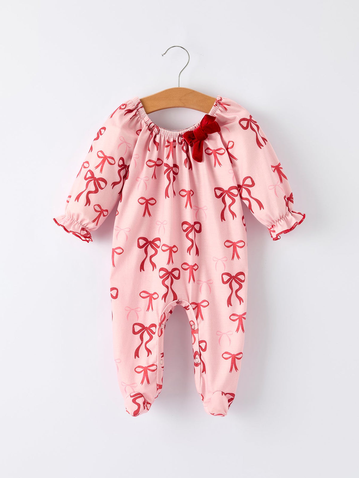 Baby Girl Romper | Pink Christmas Bow Print: Front on hanger
