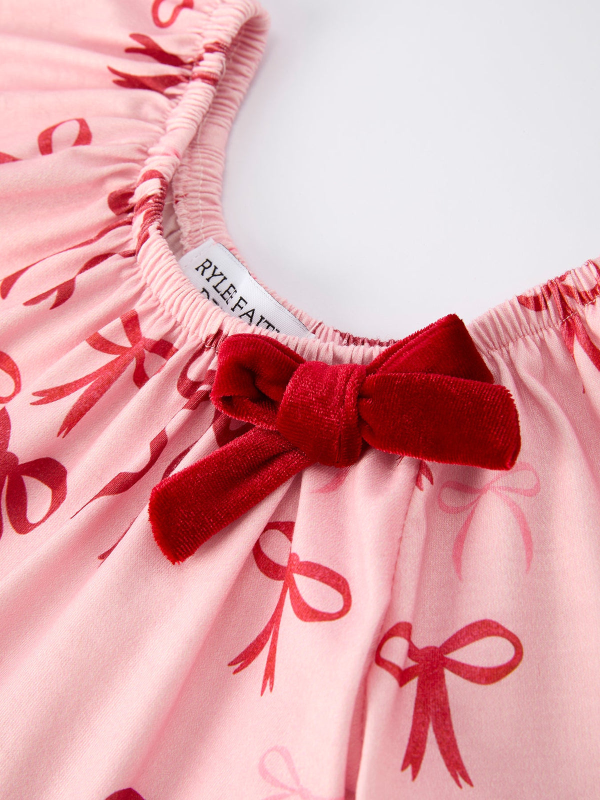 Baby Girl Romper | Pink Christmas Bow Print: Gathered neckline and red bow