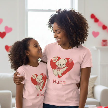 Mother and daughter wearing matching pink t-shirts with a heart design and text in a living room.