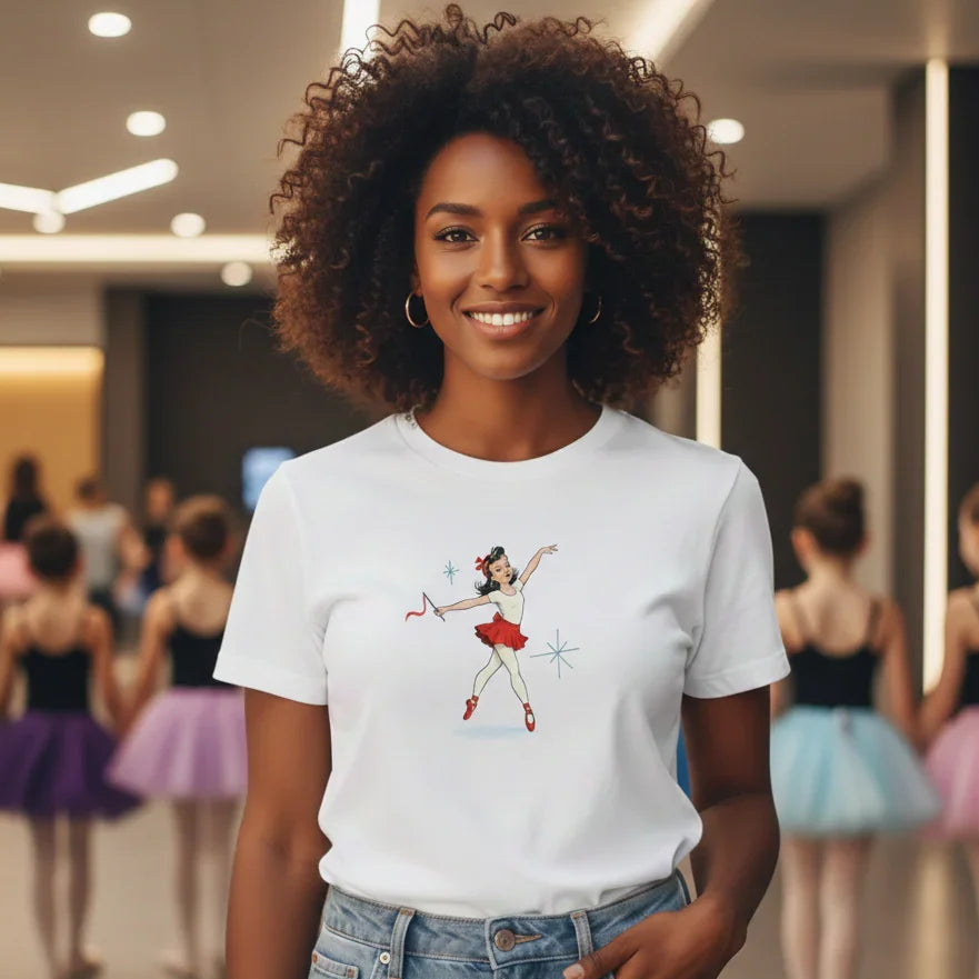 Woman wearing a white t-shirt with a graphic design of a ballerina in a dance studio.