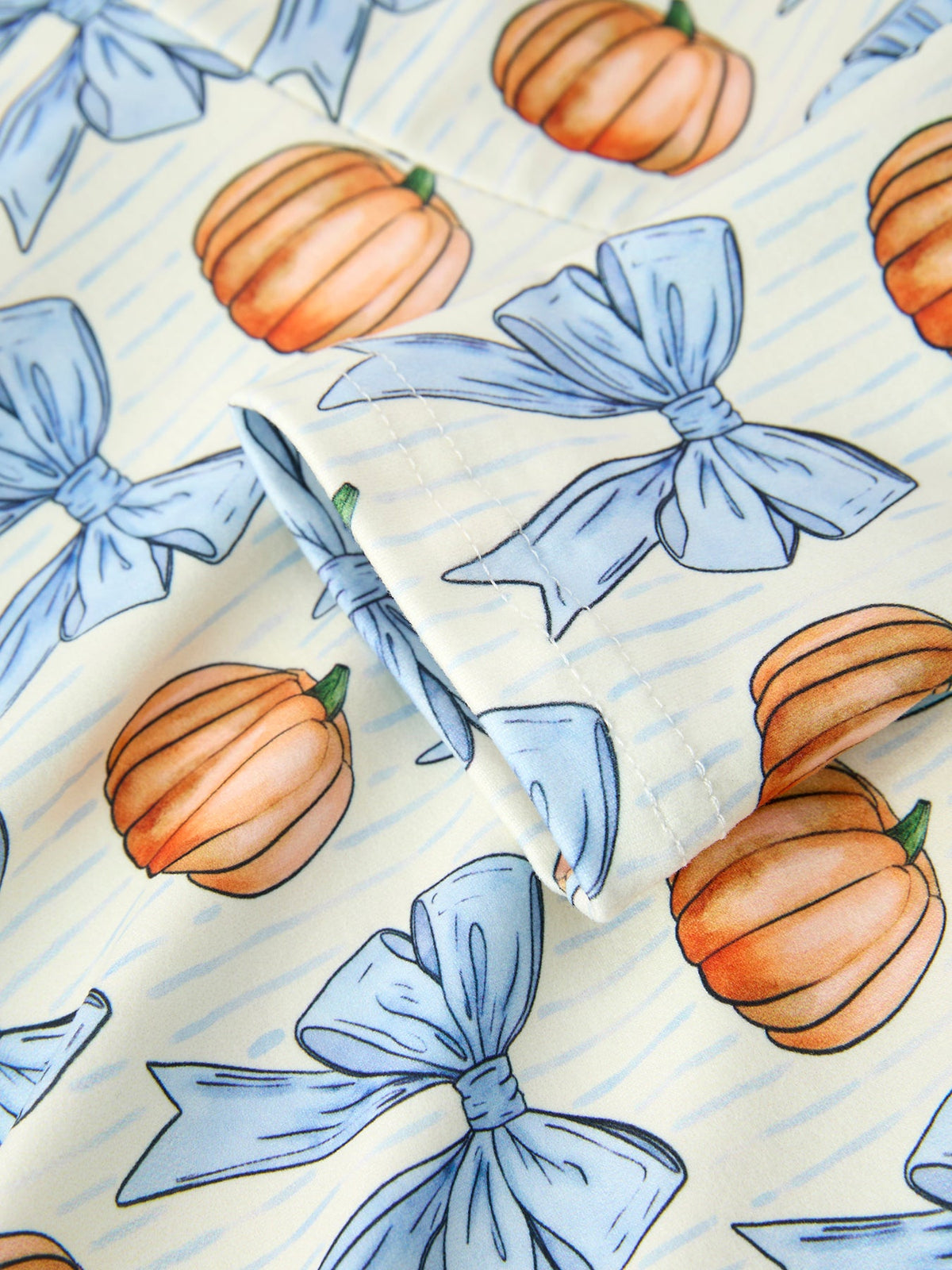 Girls Fall Dress | Blue Bow Pumpkin Print: Pumpkin and blue bow pattern detail