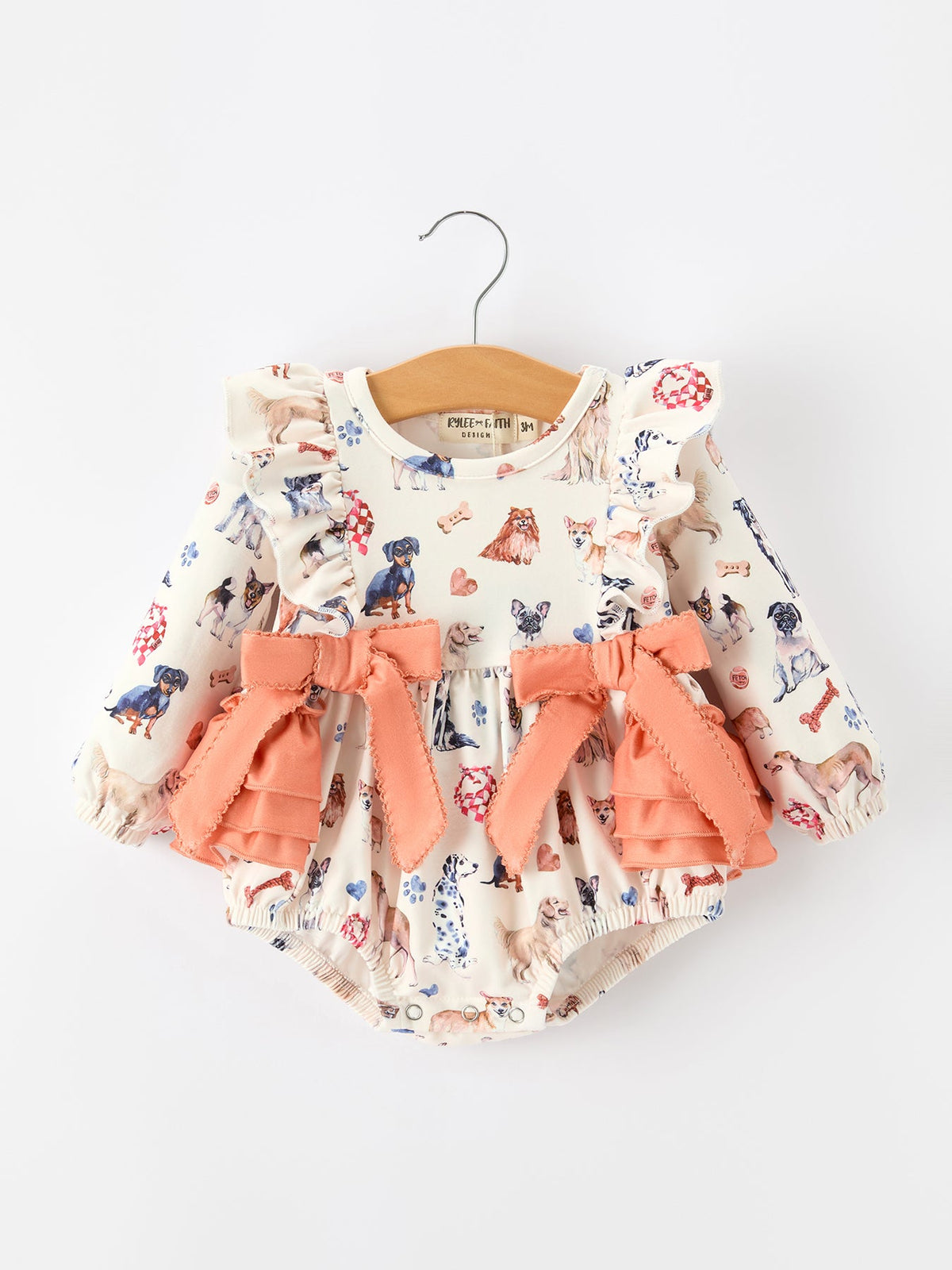 Baby Girl Romper | Fall Dogs & Ruffle Bows: Front on hanger with peach ruffles and bows