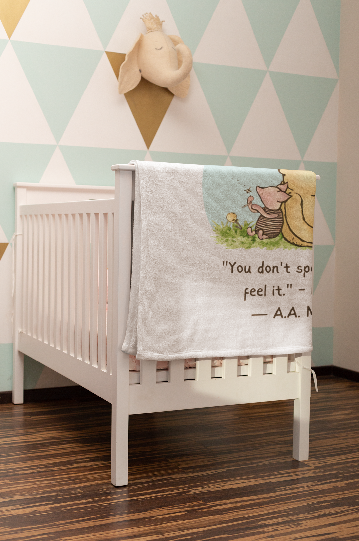White crib with a decorative blanket featuring text and graphics in a nursery setting. wtih 60 x 90 Pool How   do you spell blanket drapped on side of crib.