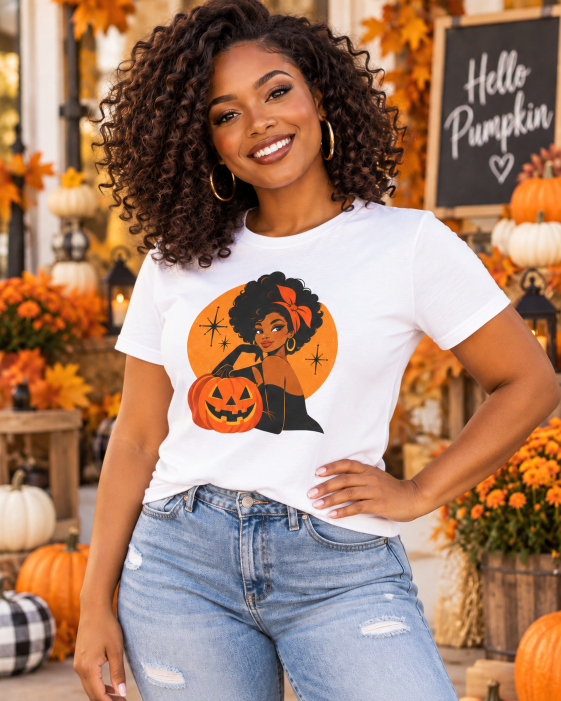 Woman in white Pumpkin Glam Halloween shirt on pumpkin decorated porch