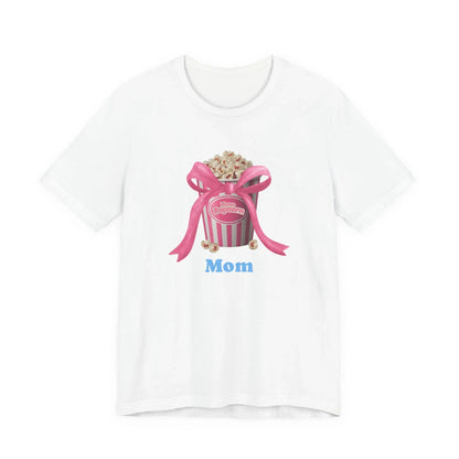 White t-shirt with pink popcorn bucket graphic, pink ribbon bow, and blue text Mom