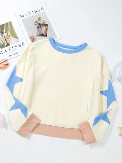 Children's sweater with blue star patterns on a white background
