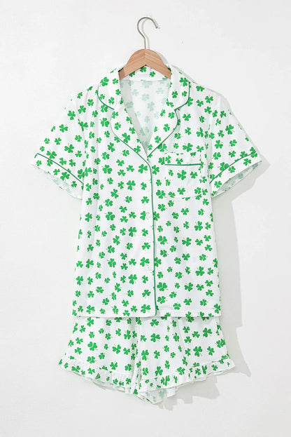 Green shamrock pattern pajama set on a hanger against a white background