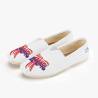 White shoes with red, white, and blue America text and red and white strip bow designs - shoes from the top left angle