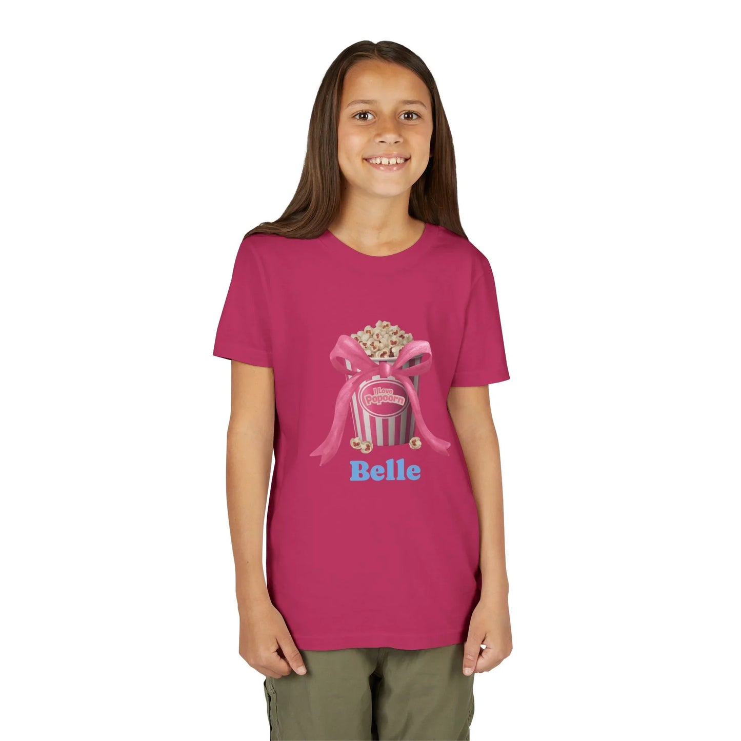 Girl wearing a magenta T-shirt with a popcorn bucket and pink ribbon graphic, name Belle
