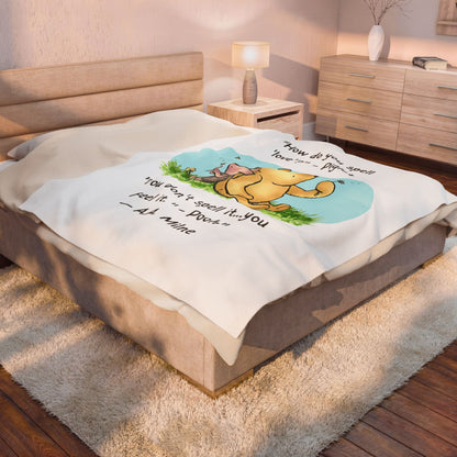 Queen Bed with a Winnie the Pooh-themed 50" x 60" blanket in a bedroom setting. Blanket is on bed sideways and takes up the majority of the bed.