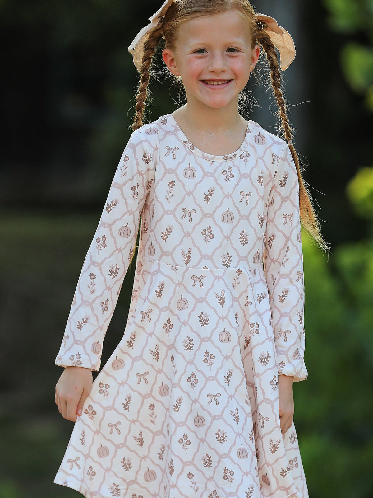 Girls Fall Dress | Pumpkin Bow Twirl: Model showing front of cream pumpkin bow dress