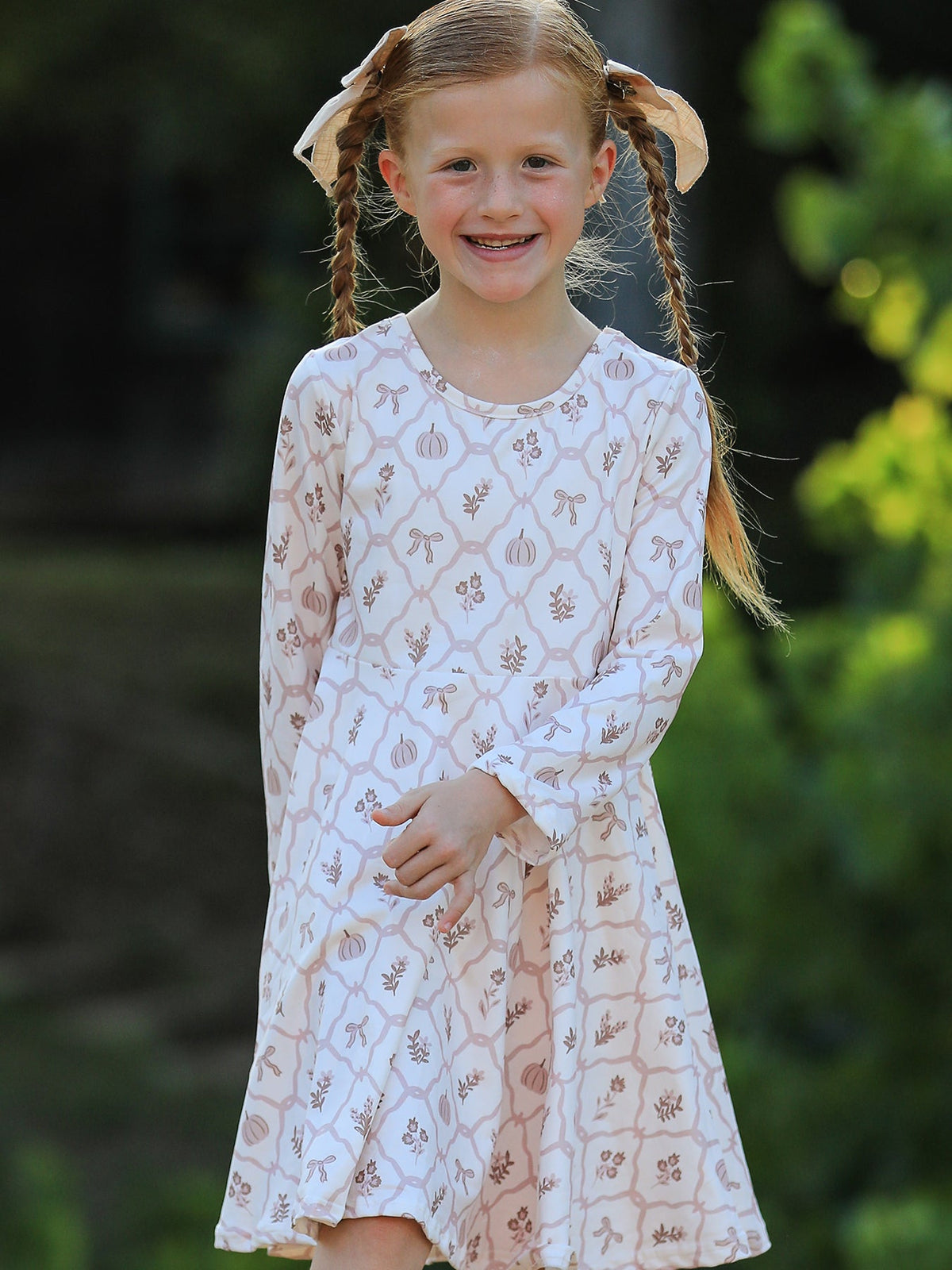 Girls Fall Dress | Pumpkin Bow Twirl: Model standing with skirt
