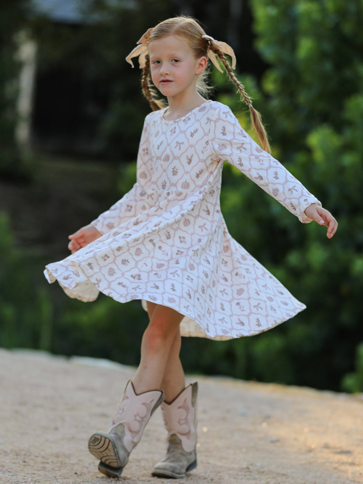Girls Fall Dress | Pumpkin Bow Twirl: Model holding skirt to one side
