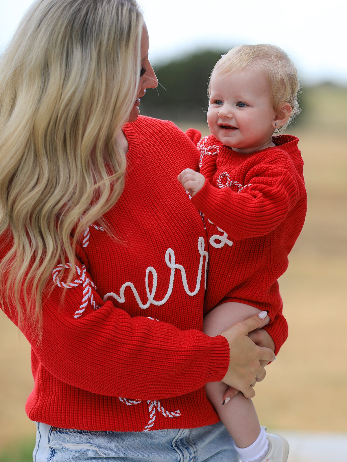 Mommy and Me Sweaters | Red Merry & Bows: Adult sweater beside separate baby romper