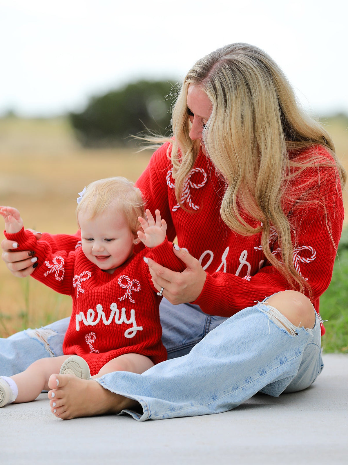 Mommy and Me Sweaters | Red Merry & Bows: Adult in red sweater beside baby in separate matching romper