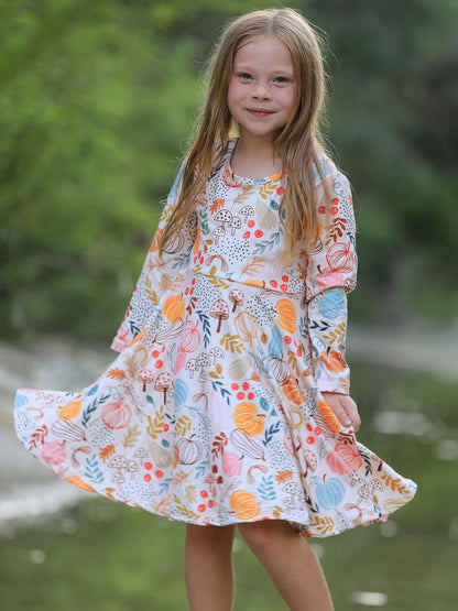 Girls Fall Dress | Pumpkin & Leaf Print: Model spreading gathered skirt