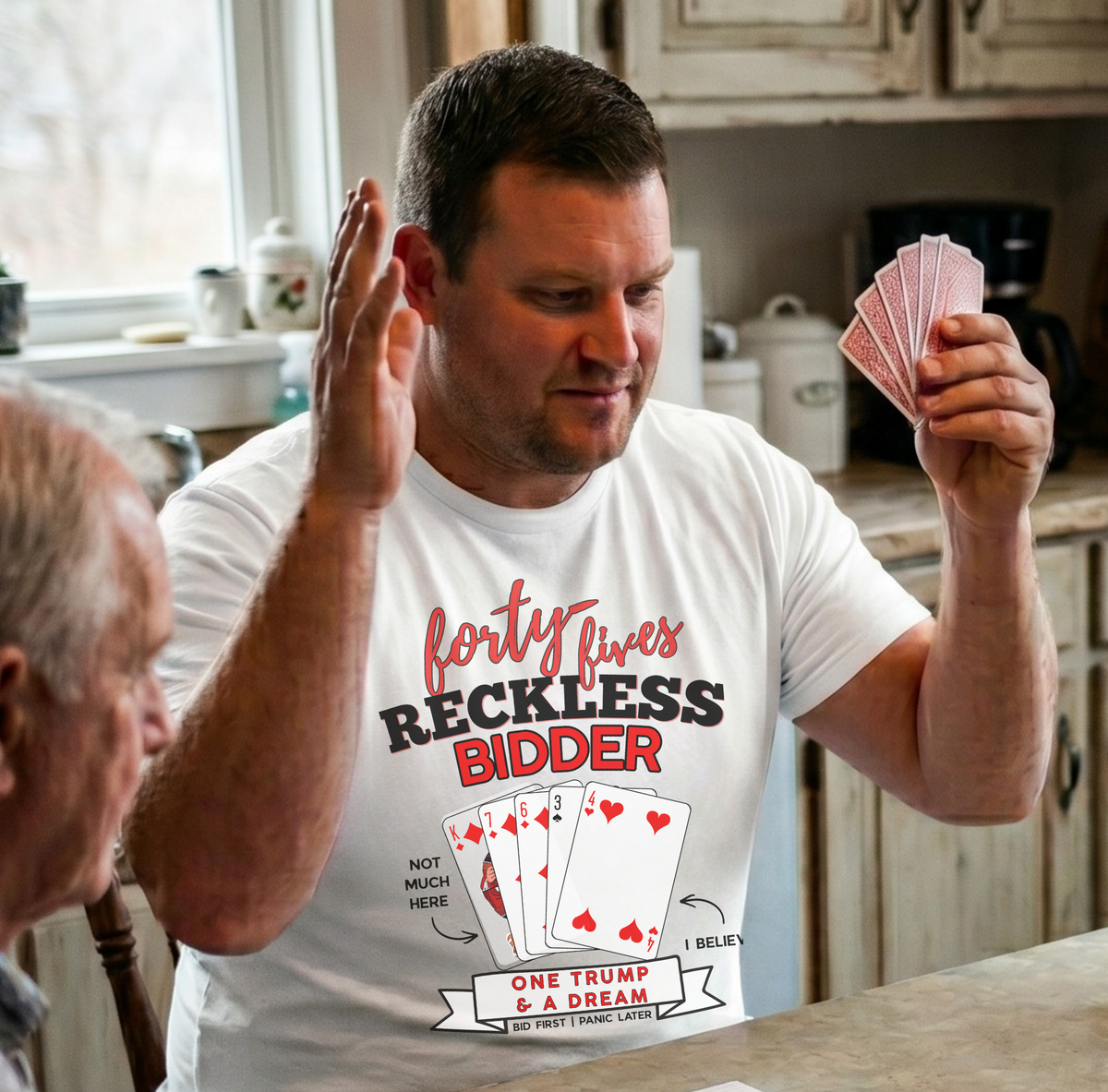 Group of people playing cards around a kitchen table.