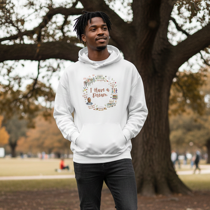 Man wearing a white hoodie with text and graphics in a park setting