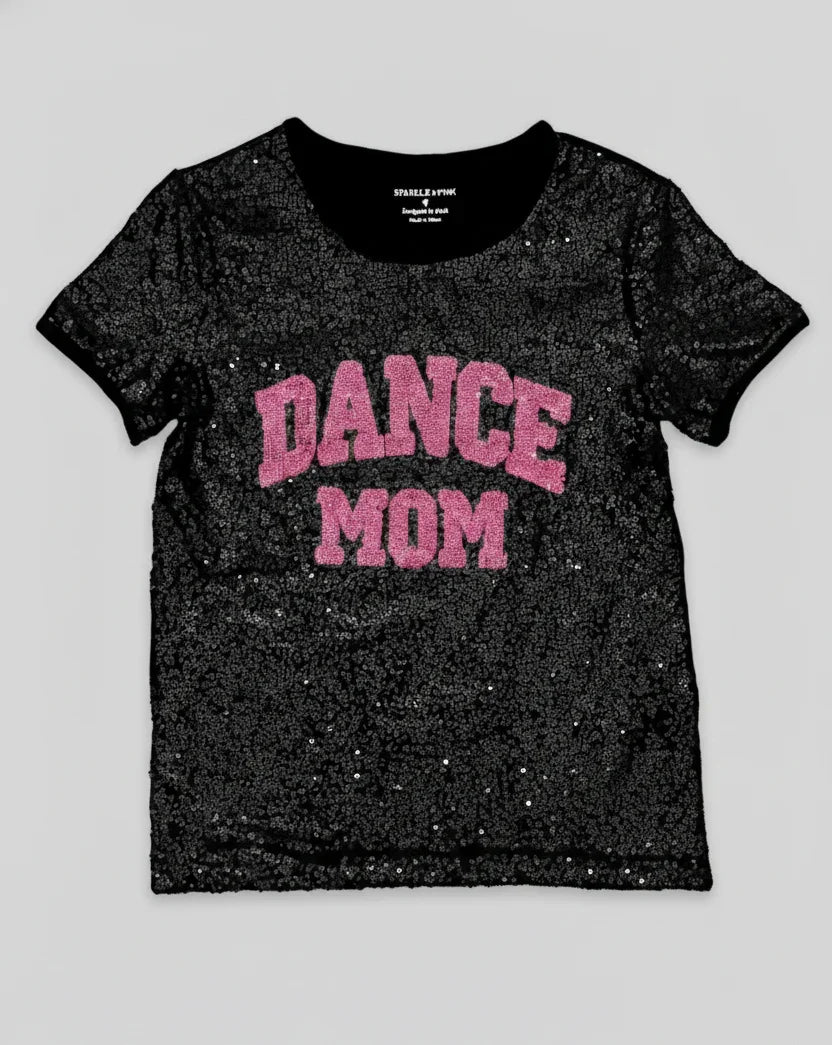 Black glittery t-shirt with 'DANCE MOM' text in pink on a light gray background