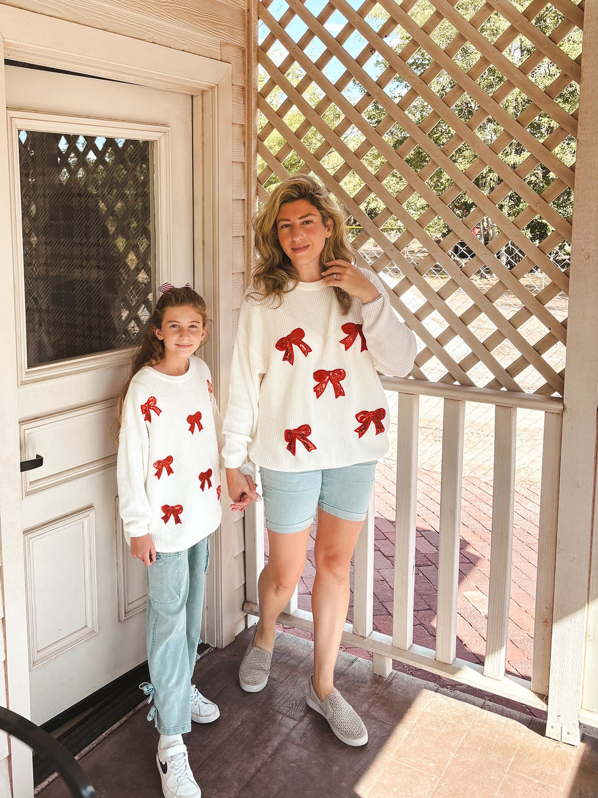 Mommy and Me Sweaters | Red Sequin Bows: Matching sweaters modeled on porch