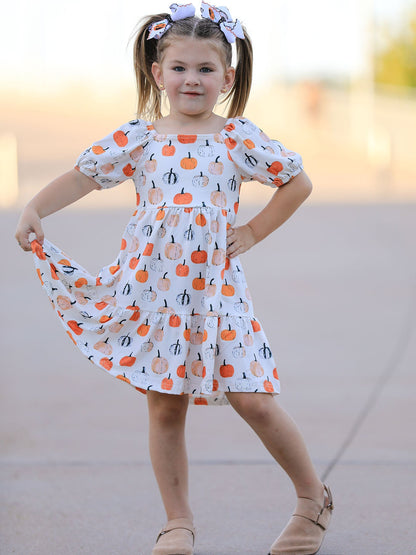 Girls Fall Dress | Pumpkin Puff Sleeves: Model holding gathered skirt