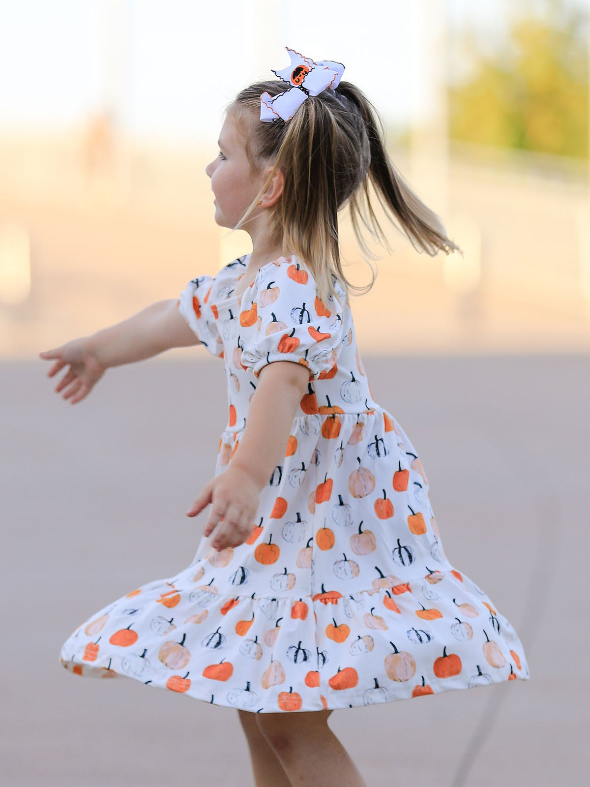 Girls Fall Dress | Pumpkin Puff Sleeves: Back view while twirling