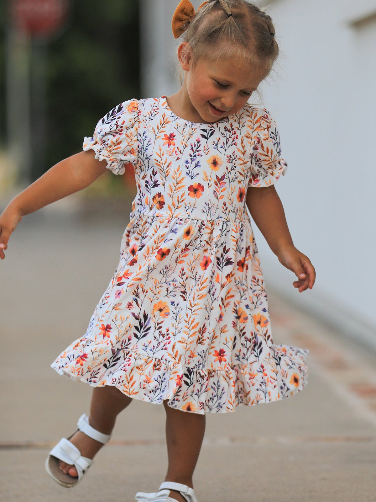 Girls Fall Dress | Floral Puff Sleeve Ruffle: Model holding floral skirt