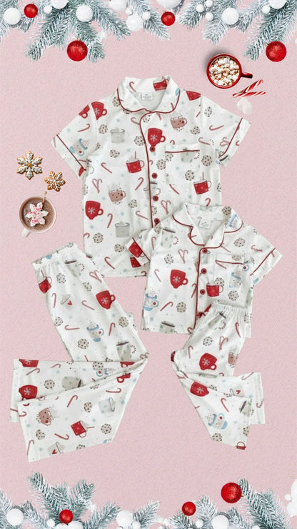 Christmas-themed pajama set with candy cane and candy design on a pink background.