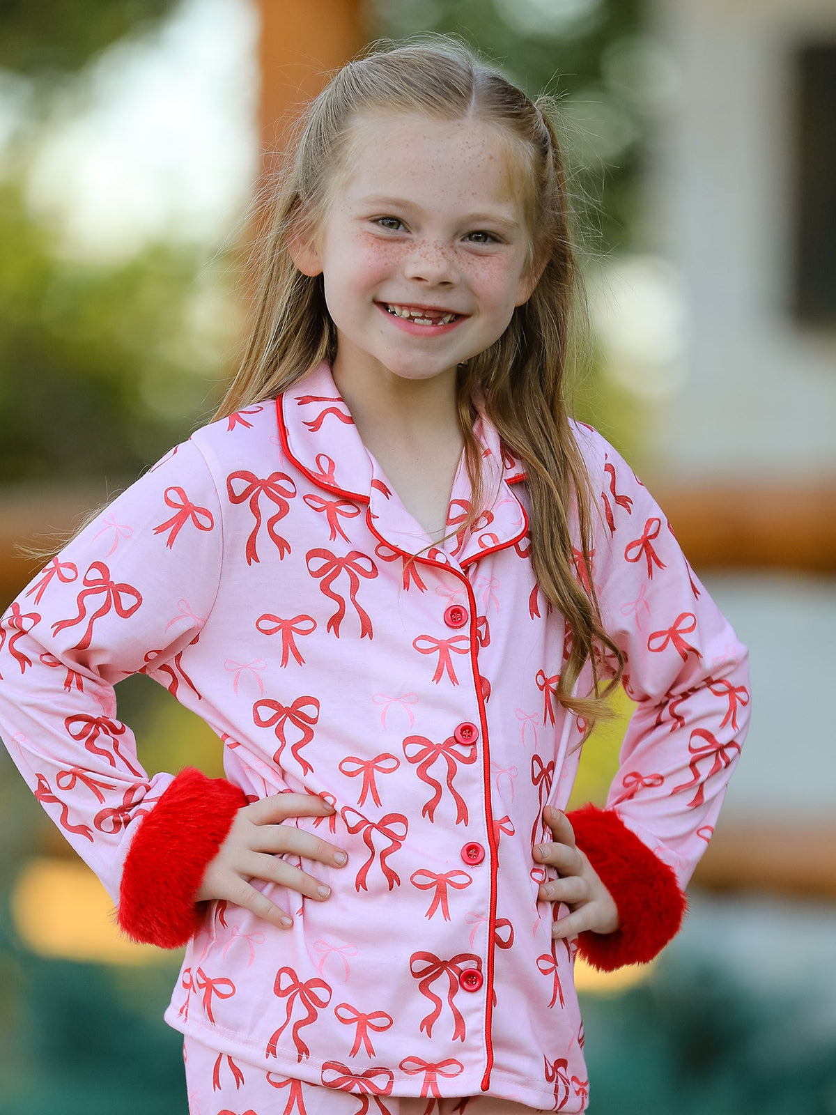 Girls Christmas Pajamas | Pink Bow Furry Trim: Collar piping and red furry cuffs on model