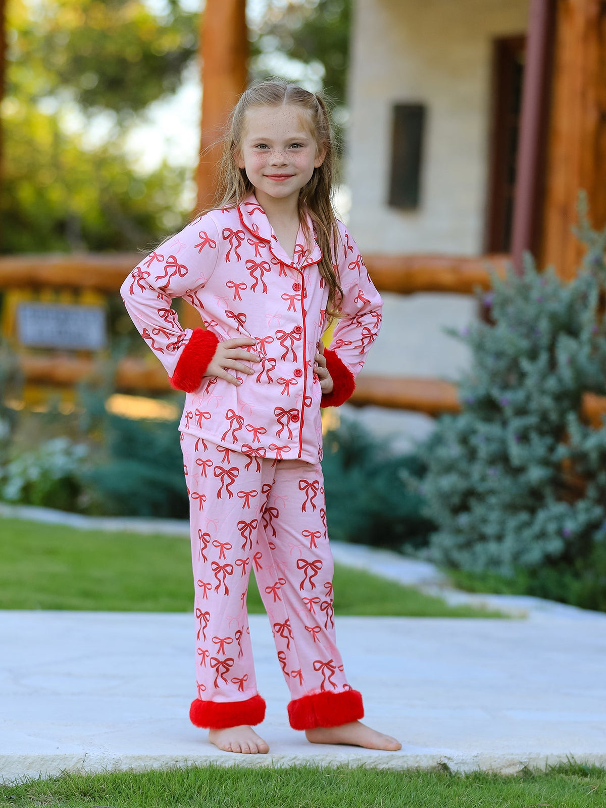 Girls Christmas Pajamas | Pink Bow Furry Trim: Model showing front of pink bow set