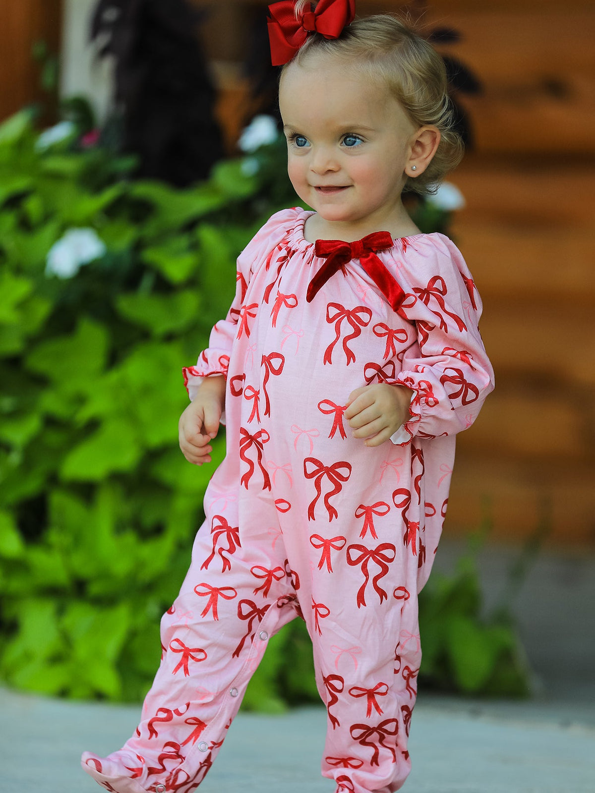 Baby Girl Romper | Pink Christmas Bow Print: Baby showing red neck bow