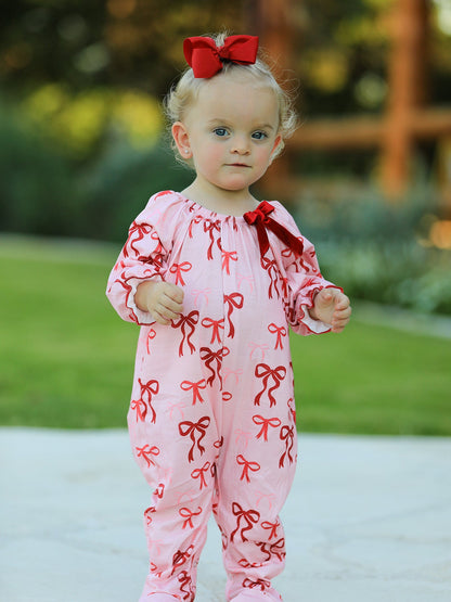 Baby Girl Romper | Pink Christmas Bow Print: Baby wearing pink red-bow romper front