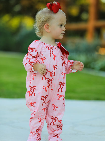 Baby Girl Romper | Pink Christmas Bow Print: Baby wearing romper side view