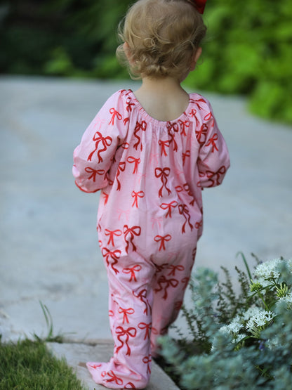 Baby Girl Romper | Pink Christmas Bow Print: Back view on baby